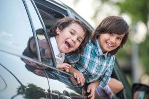 kids smiling in car