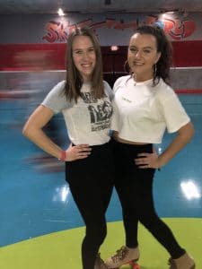 two girls at at a roller skating rink