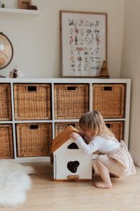 Little girl looking in toy box