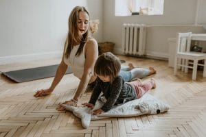 Mother and small daughter doing yoga