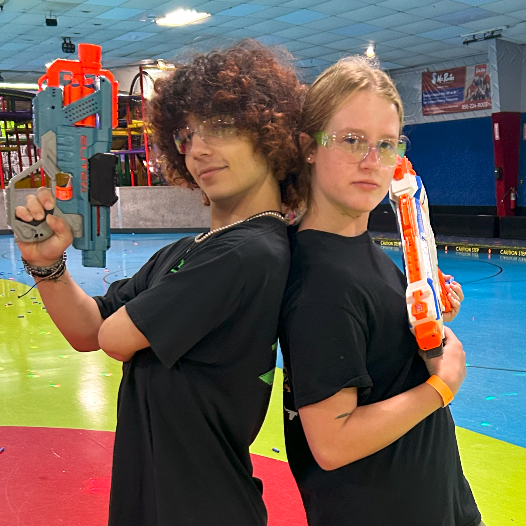 two young people holding Nerf blasters for our Nerf Nite event.