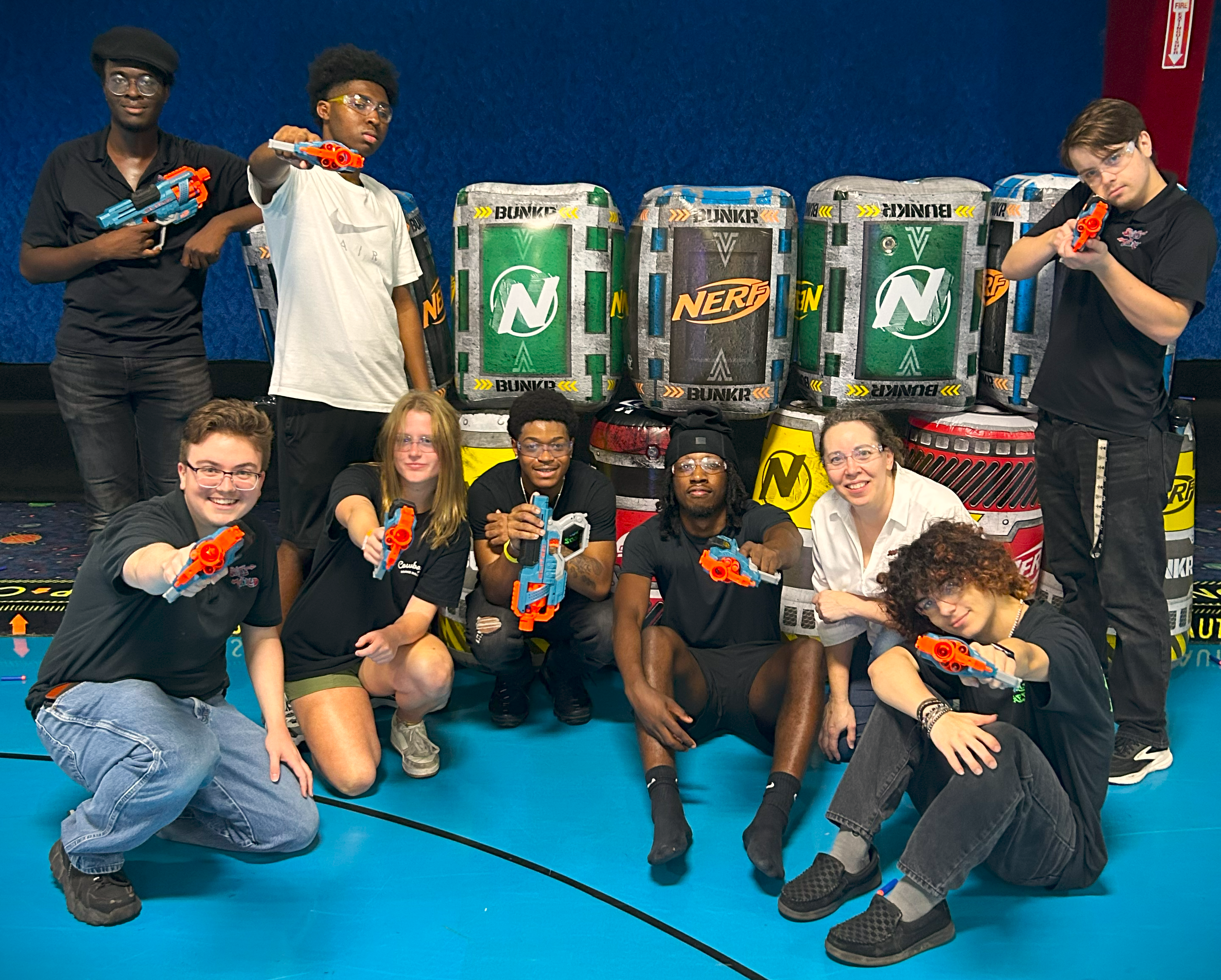 Skate World staff holding Nerf Blasters during training for our Nerf Nite event.