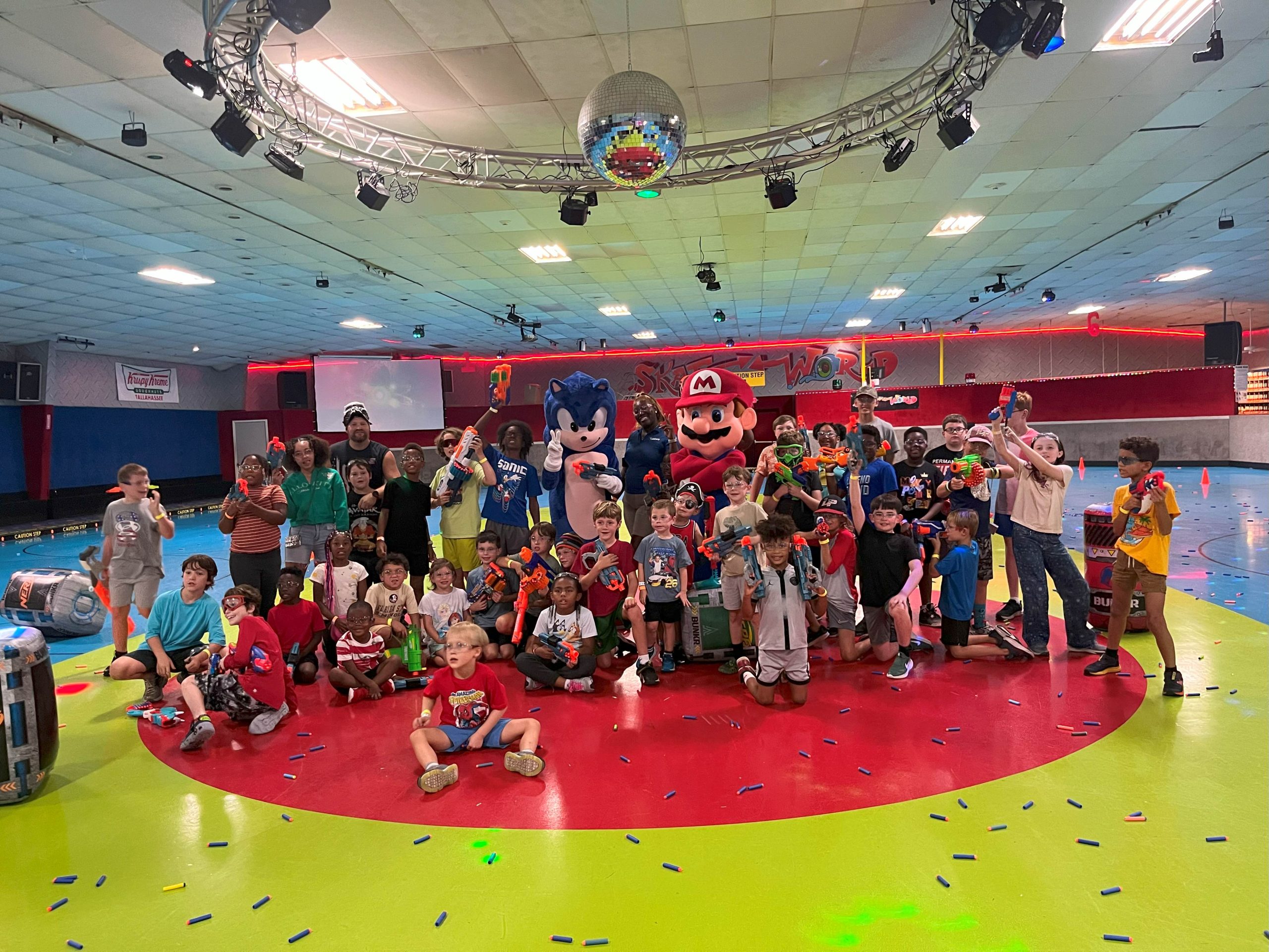 Skate World staff holding Nerf Blasters during training for our Nerf Nite event.
